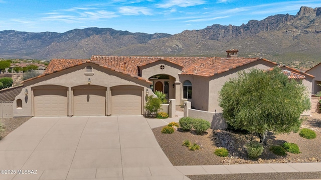 11028 N Pusch Ridge View Pl, Oro Valley, AZ 85737 - mediterranean / spanish home with a garage, a tiled roof, stucco siding, concrete driveway, and a mountain view