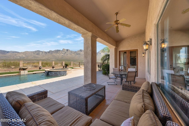 11028 N Pusch Ridge View Pl, Oro Valley, AZ 85737 - view of patio / terrace with a mountain view, an outdoor hangout area, a ceiling fan, and a pool with connected hot tub