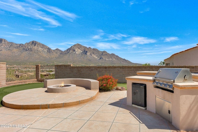 11028 N Pusch Ridge View Pl, Oro Valley, AZ 85737 - view of patio featuring an outdoor fire pit and a mountain view