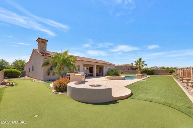 11028 N Pusch Ridge View Pl, Oro Valley, AZ 85737 - back of property with a patio area, an area to practice putting, stucco siding, and a fenced backyard