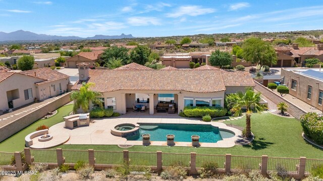 11028 N Pusch Ridge View Pl, Oro Valley, AZ 85737 - view of swimming pool featuring a fire pit, a patio area, a pool with connected hot tub, a residential view, and a mountain view