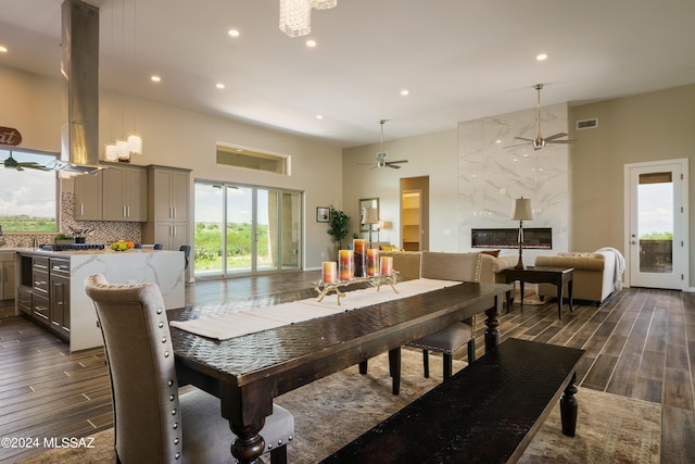 dining area featuring recessed lighting, a high ceiling, a ceiling fan, and dark wood finished floors