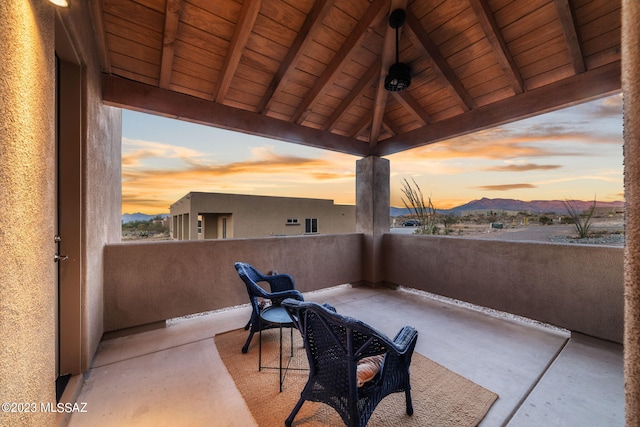 patio terrace at dusk featuring a gazebo and a balcony