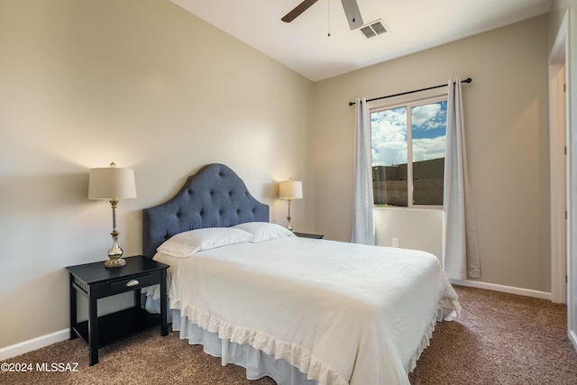 carpeted bedroom with baseboards, visible vents, and ceiling fan