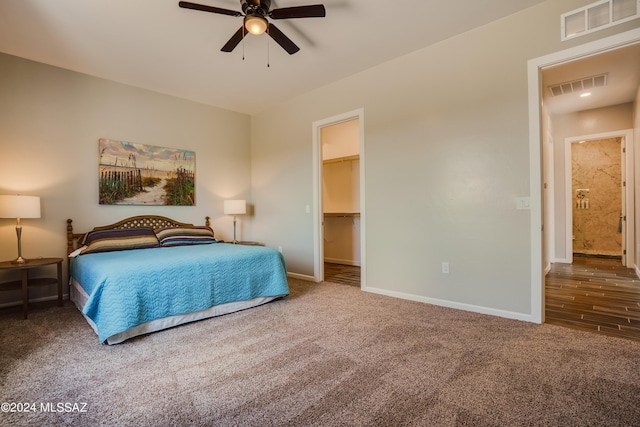 carpeted bedroom featuring baseboards, ceiling fan, and visible vents