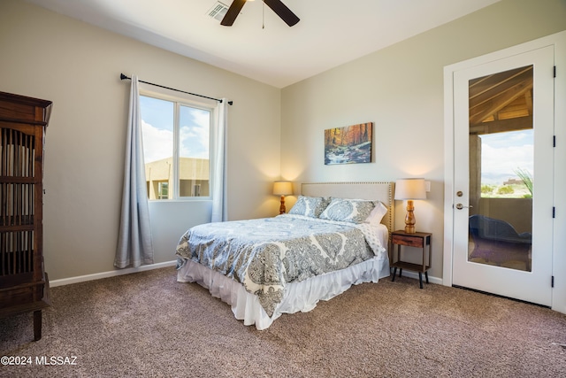 carpeted bedroom featuring baseboards, access to outside, a ceiling fan, and visible vents