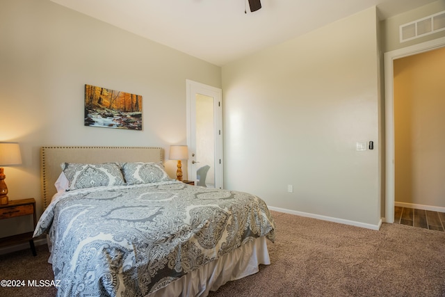 carpeted bedroom featuring visible vents, a ceiling fan, and baseboards
