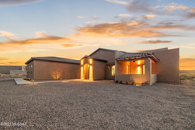 view of front of property with a tiled roof and stucco siding