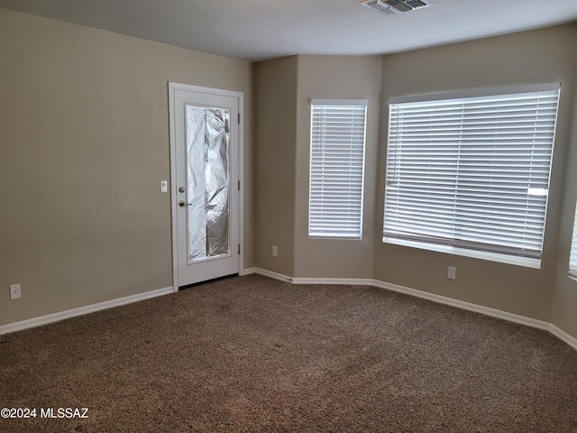 carpeted foyer entrance featuring visible vents and baseboards