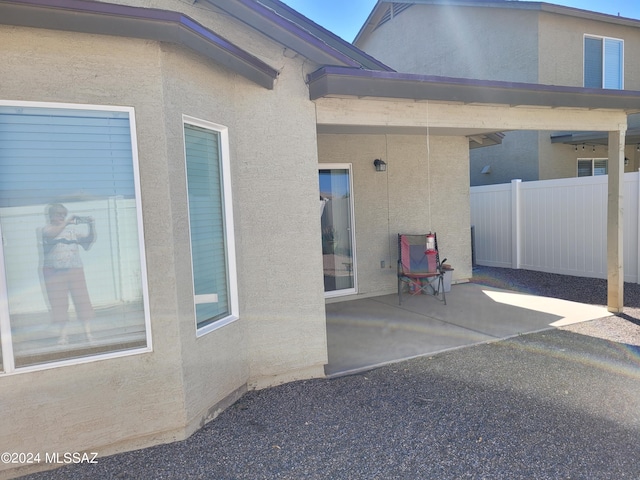 exterior space with a patio, stucco siding, and fence