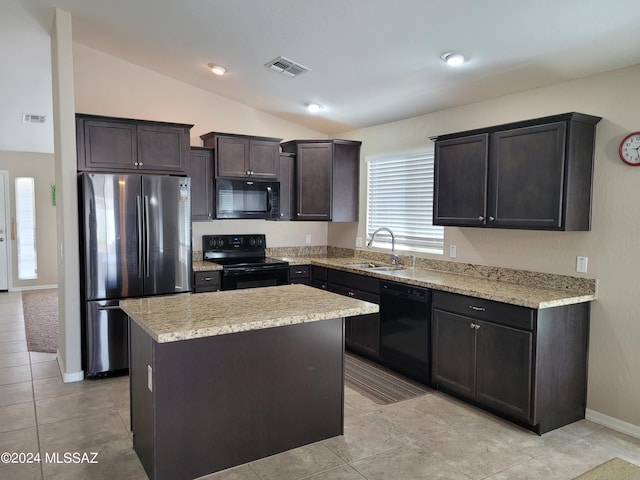 kitchen featuring visible vents, a sink, black appliances, a kitchen island, and lofted ceiling