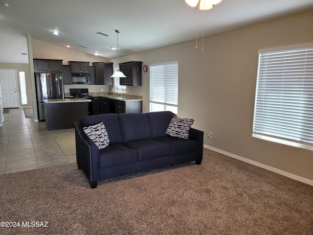 living area with light carpet, baseboards, lofted ceiling, and visible vents
