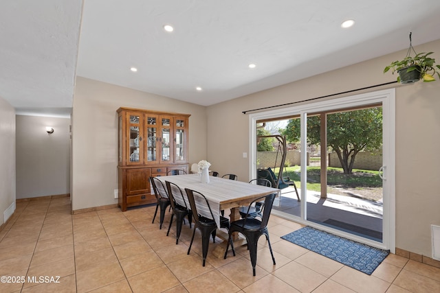 dining space with baseboards, recessed lighting, light tile patterned flooring, and vaulted ceiling