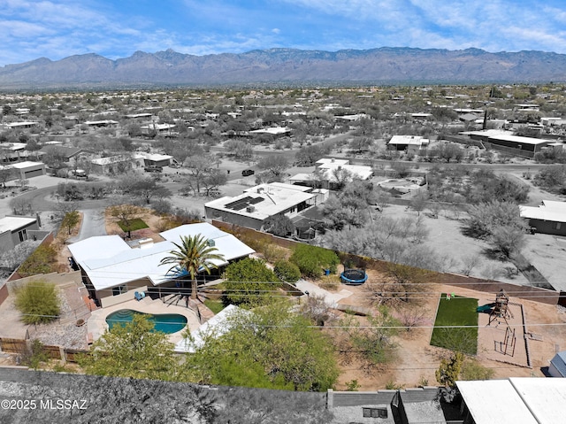 aerial view of residential area with mountains and a pool