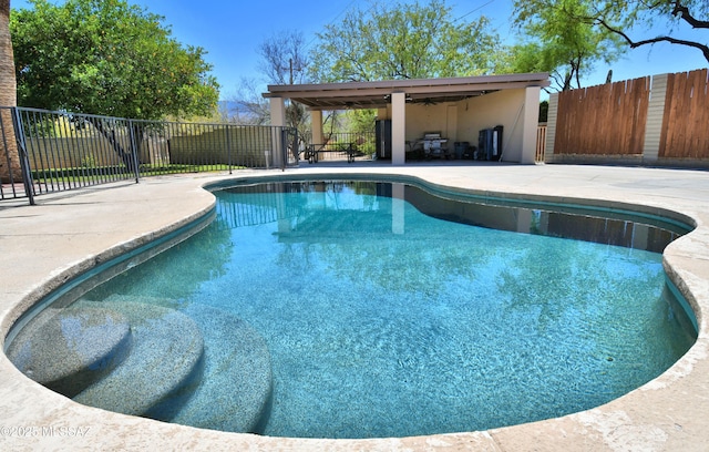 view of swimming pool featuring a patio area, a fenced backyard, and ceiling fan