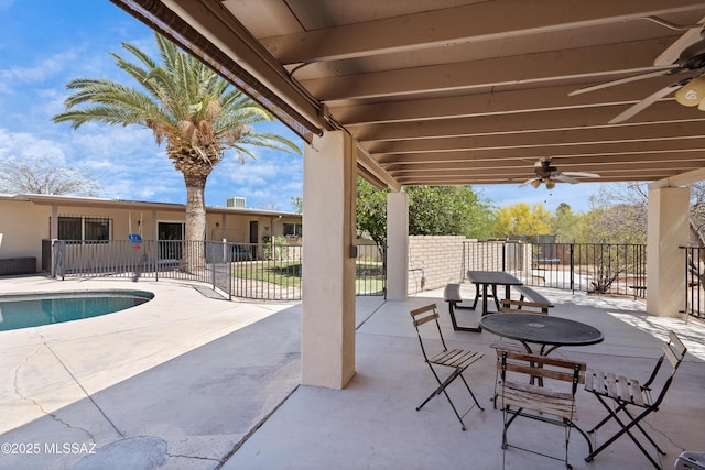 view of patio / terrace with ceiling fan and fence