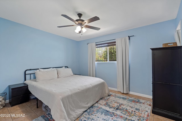 bedroom featuring baseboards, light tile patterned floors, and ceiling fan