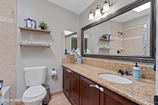 bathroom with a shower with curtain, toilet, tile patterned flooring, vanity, and baseboards