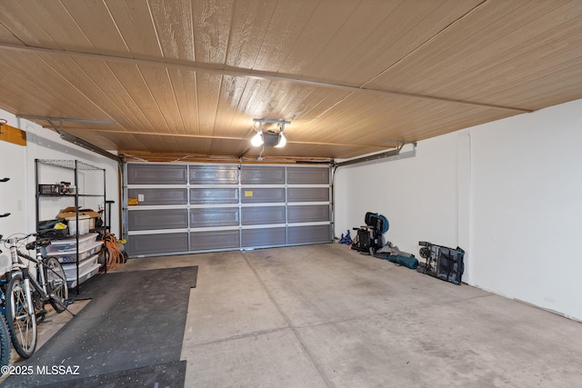 garage featuring wood ceiling and a garage door opener