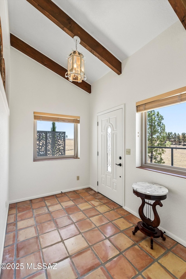 20 Buckskin Ln, Sonoita, AZ 85637 - foyer entrance featuring an inviting chandelier, baseboards, beamed ceiling, and a wealth of natural light