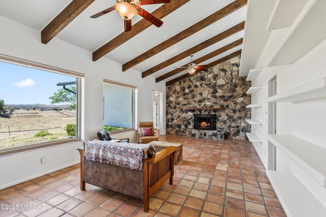 20 Buckskin Ln, Sonoita, AZ 85637 - living area featuring light tile patterned flooring, a fireplace, a ceiling fan, baseboards, and vaulted ceiling with beams