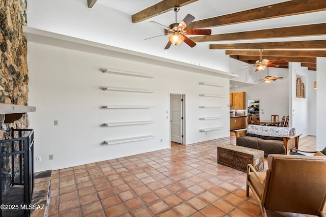 20 Buckskin Ln, Sonoita, AZ 85637 - living area with ceiling fan, beam ceiling, and a fireplace