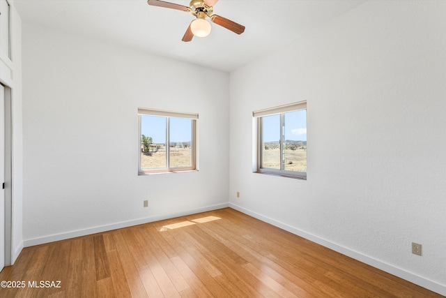 20 Buckskin Ln, Sonoita, AZ 85637 - unfurnished room featuring baseboards, ceiling fan, a wealth of natural light, and light wood finished floors