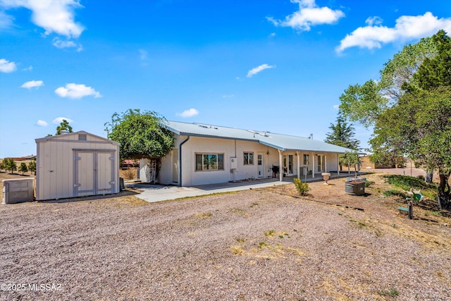 20 Buckskin Ln, Sonoita, AZ 85637 - back of property with a storage unit, a patio, and an outbuilding