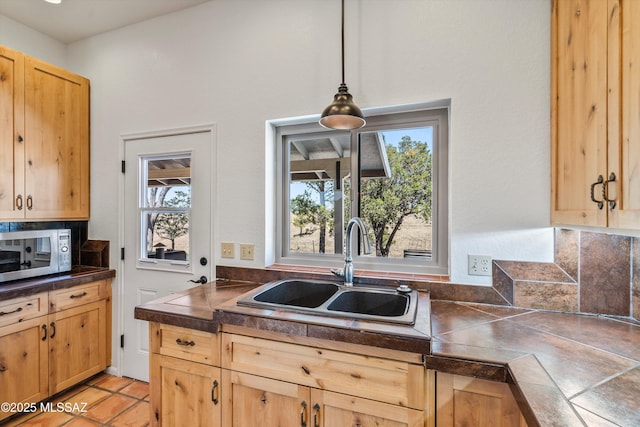20 Buckskin Ln, Sonoita, AZ 85637 - kitchen with a sink, light brown cabinetry, stainless steel microwave, and pendant lighting