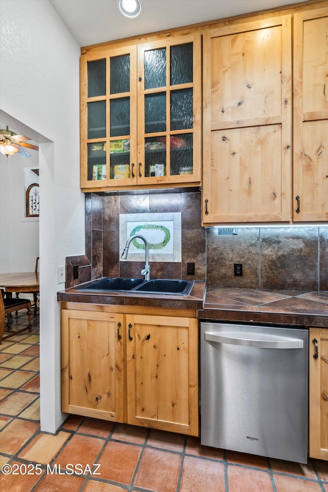 20 Buckskin Ln, Sonoita, AZ 85637 - kitchen with decorative backsplash, dark countertops, dishwasher, a sink, and light brown cabinets