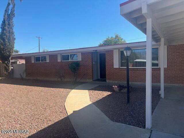 exterior space featuring brick siding