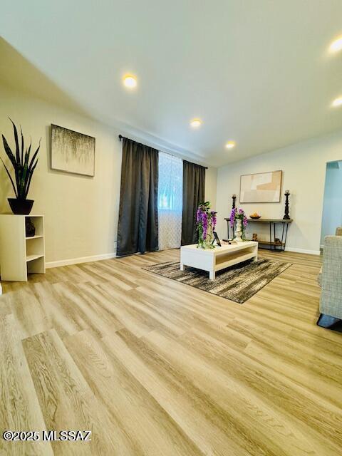 interior space featuring wood finished floors, baseboards, and recessed lighting