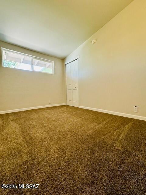 empty room with carpet floors and baseboards