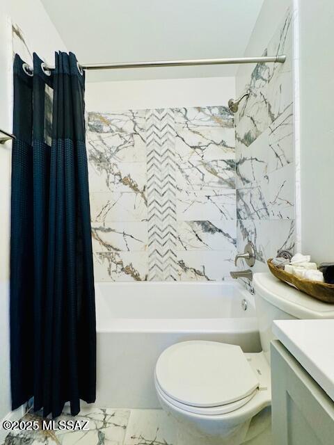 bathroom featuring toilet, shower / bath combo with shower curtain, marble finish floor, and vanity