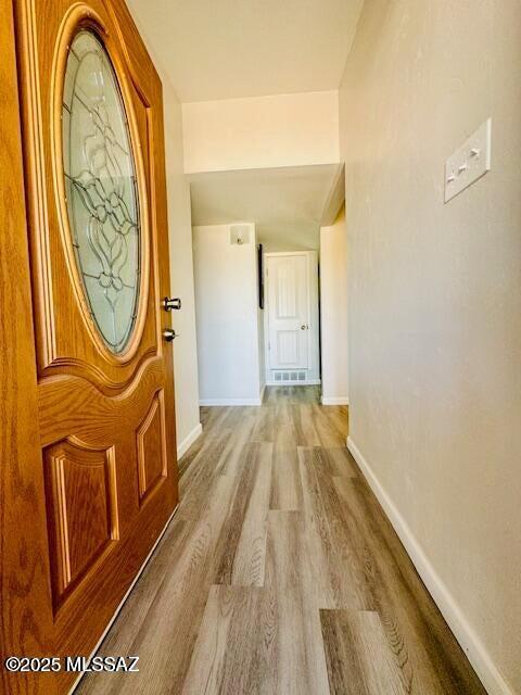 interior space with wood finished floors and baseboards