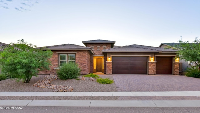 13711 N Hidden Springs Dr, Oro Valley, AZ 85755 - prairie-style house featuring decorative driveway, a garage, stone siding, and stucco siding