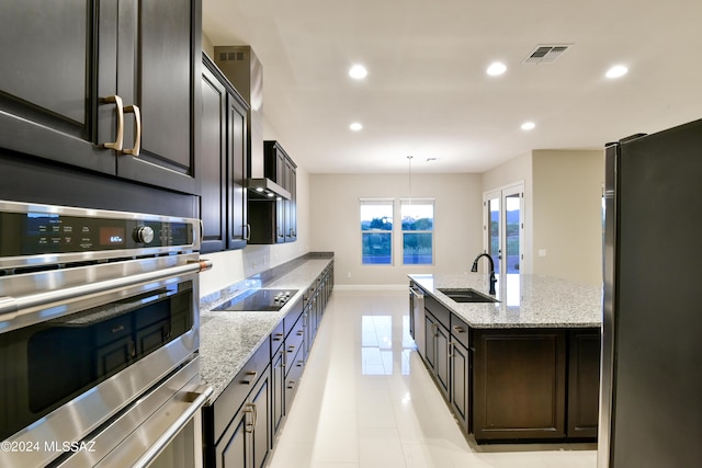 13711 N Hidden Springs Dr, Oro Valley, AZ 85755 - kitchen with stainless steel appliances, a sink, recessed lighting, light tile patterned floors, and light stone countertops