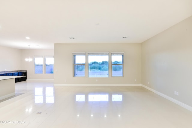 13711 N Hidden Springs Dr, Oro Valley, AZ 85755 - unfurnished living room with baseboards, light tile patterned floors, recessed lighting, and a chandelier