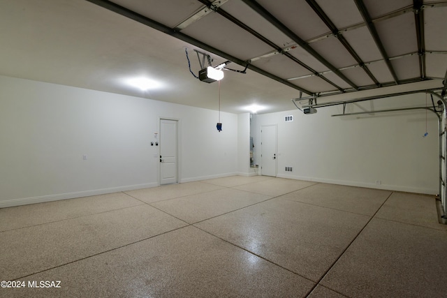 13711 N Hidden Springs Dr, Oro Valley, AZ 85755 - garage featuring a garage door opener and baseboards