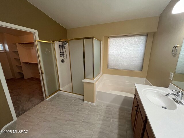 60954 Rock Ledge Loop, Tucson, AZ 85739 - full bathroom with a shower stall, vaulted ceiling, vanity, a garden tub, and a walk in closet