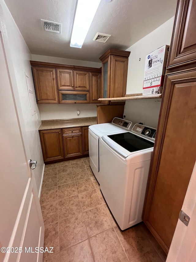60954 Rock Ledge Loop, Tucson, AZ 85739 - clothes washing area with separate washer and dryer, cabinet space, and light tile patterned floors