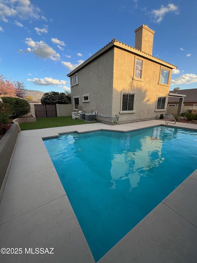60954 Rock Ledge Loop, Tucson, AZ 85739 - view of swimming pool featuring central air condition unit, fence, and a patio area