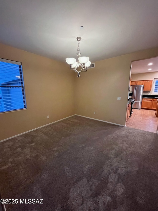 60954 Rock Ledge Loop, Tucson, AZ 85739 - spare room featuring a chandelier, baseboards, and light colored carpet