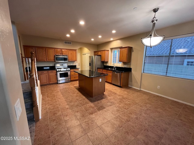 60954 Rock Ledge Loop, Tucson, AZ 85739 - kitchen featuring appliances with stainless steel finishes, dark countertops, arched walkways, recessed lighting, and a sink