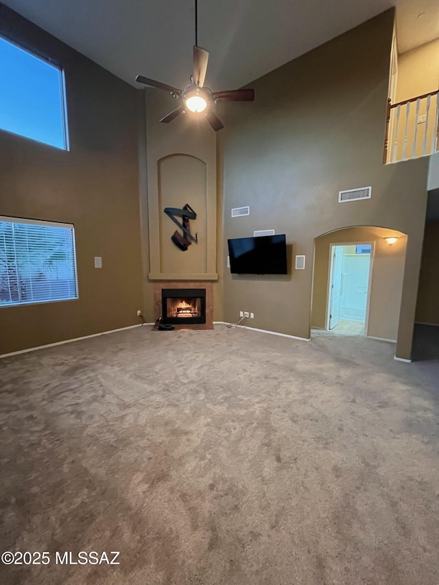 60954 Rock Ledge Loop, Tucson, AZ 85739 - unfurnished living room featuring high vaulted ceiling, a ceiling fan, a fireplace, carpet floors, and baseboards