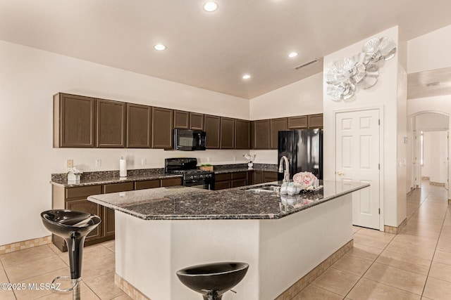 kitchen featuring visible vents, a sink, black appliances, and light tile patterned flooring