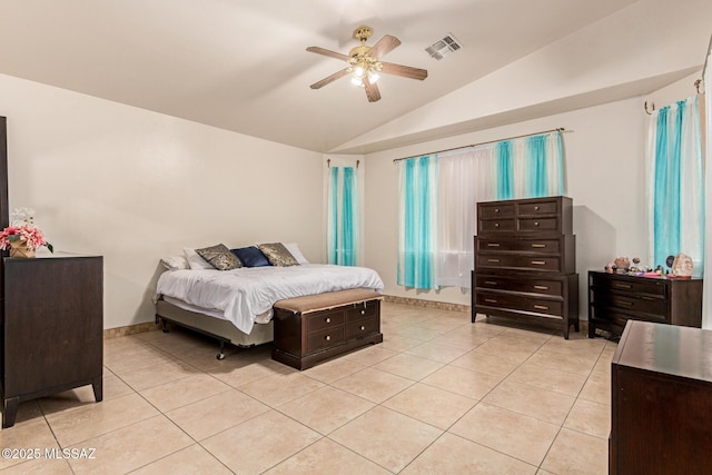 bedroom featuring vaulted ceiling, visible vents, light tile patterned floors, baseboards, and ceiling fan