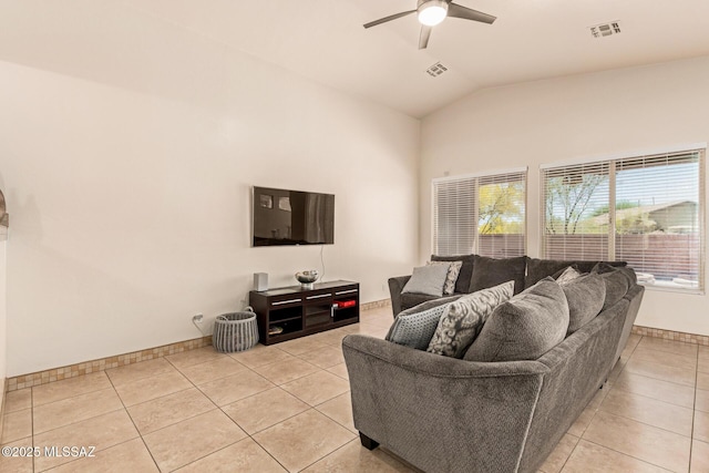living area with lofted ceiling, visible vents, ceiling fan, and light tile patterned floors