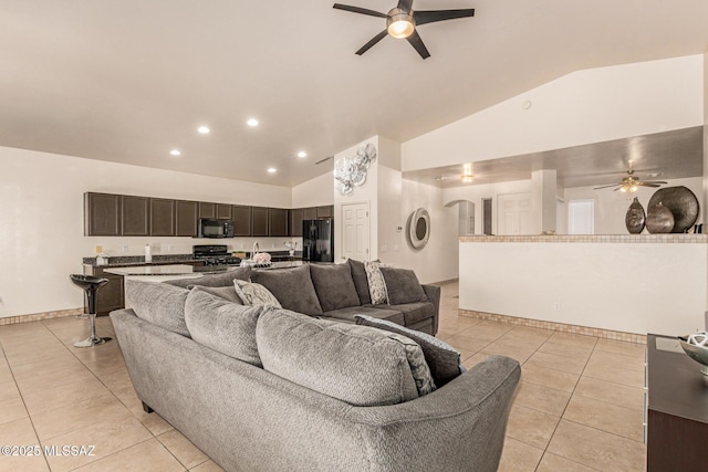 living room featuring high vaulted ceiling, a ceiling fan, baseboards, and light tile patterned floors