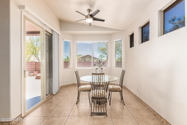 dining space with plenty of natural light, vaulted ceiling, ceiling fan, and light tile patterned flooring